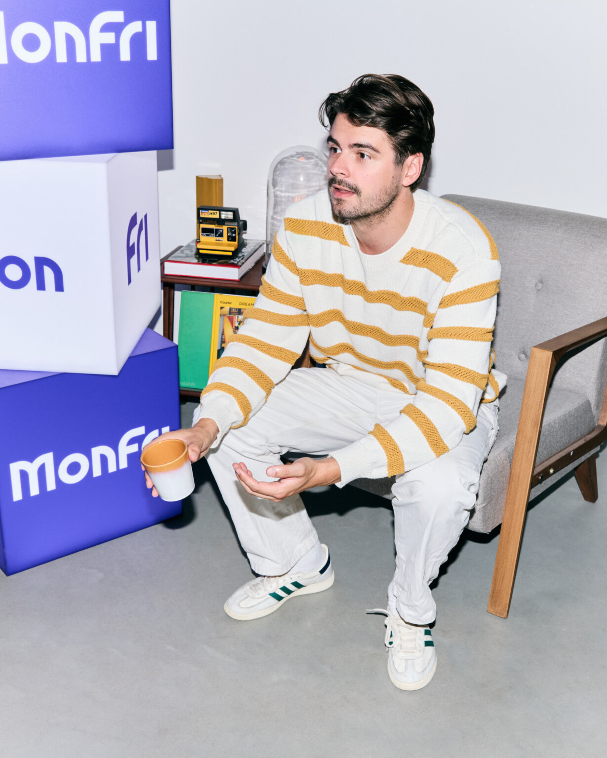 MonFri colleague by the brand cubes at the Amsterdam office